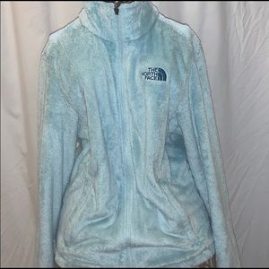 A turquoise The North Face zip up jacket